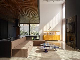 living space with yellow furniture at Villa XY by Mohamed Amine Siana