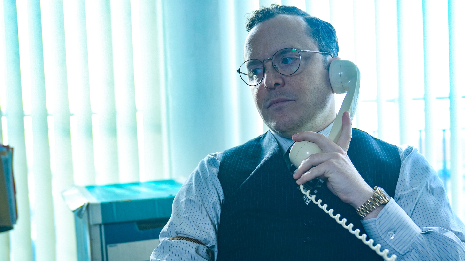 Douglas sits on the phone in The Gold season 2