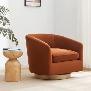 light brown velvet rounded armchair with a swivel base