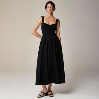 model wears black poplin dress with sweetheart neckline