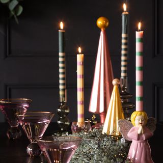 Christmas table decorated with pink and green taper candles