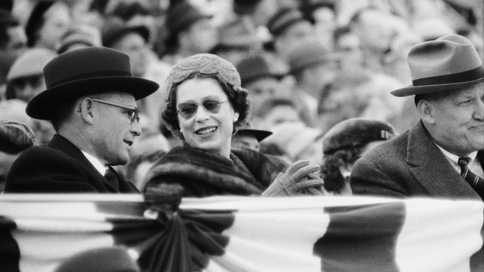 Queen Elizabeth attends a college football game in Maryland, president Eisenhower is to her right