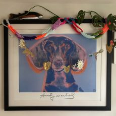 art work with knitted paper chains draped across the top