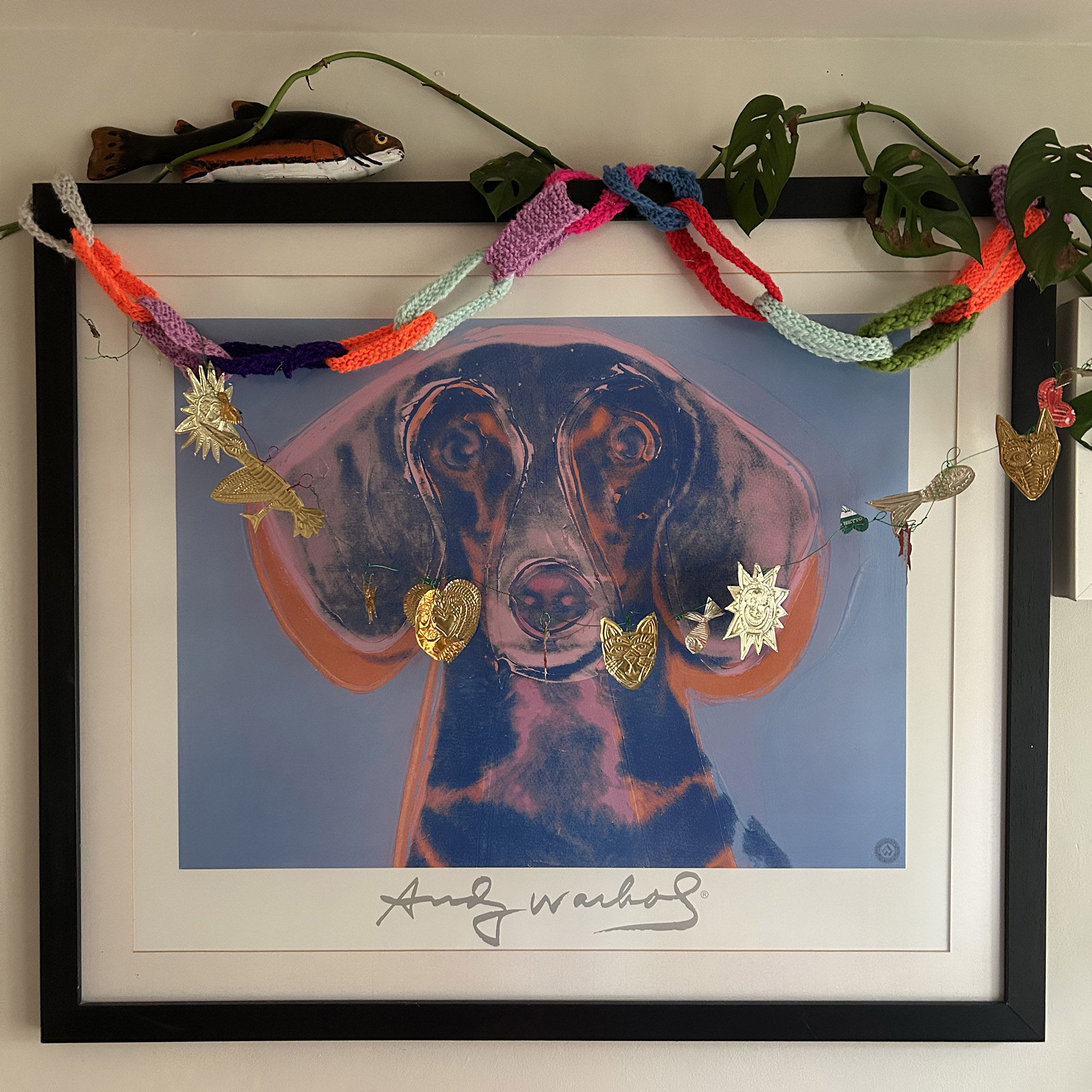 art work with knitted paper chains draped across the top