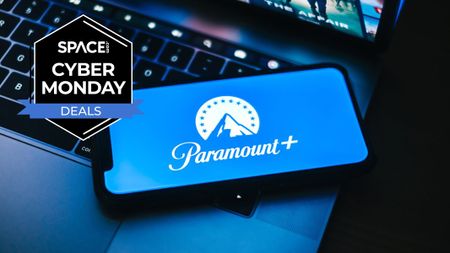 A laptop with a smartphone on top with a Paramount+ logo on screen. To the top left is a space.com cyber monday deals icon
