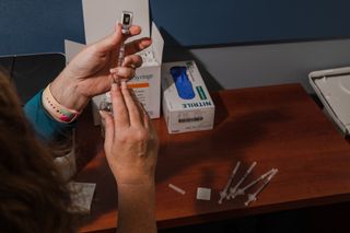 A nurse prepares a Pfizer-BioNTech coronavirus vaccine at McLeod Health Clarendon Hospitals in South Carolina on Dec. 17.