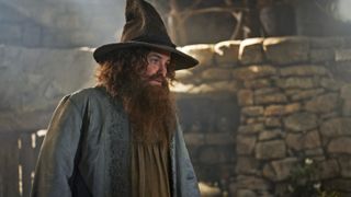 Tom Bombadil stands in his Rhun-based hut in The Rings of Power season 2