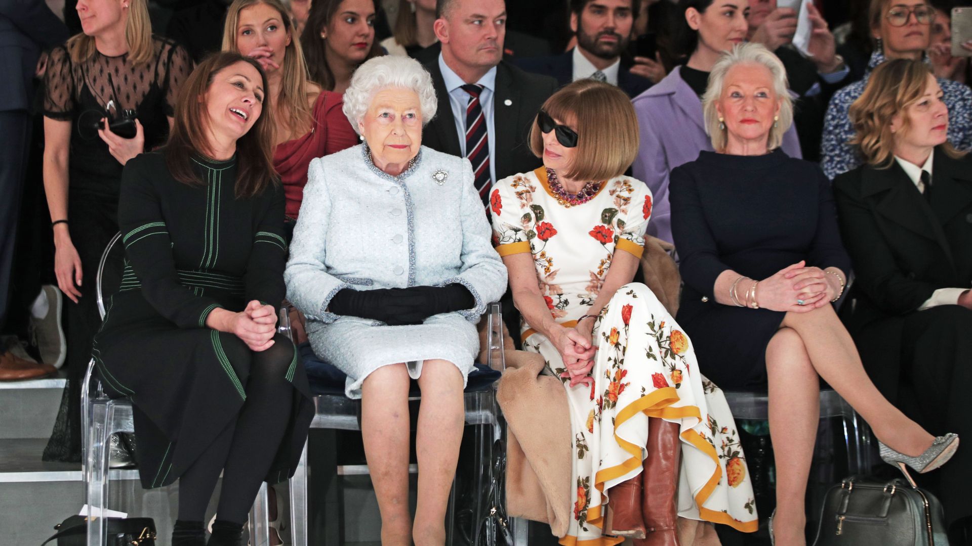 Queen Elizabeth II sits with Anna Wintour (third right) and Caroline Rush, chief executive of the British Fashion Council (BFC) (left) and royal dressmaker Angela Kelly (second right) during a 2018 London Fashion Week show