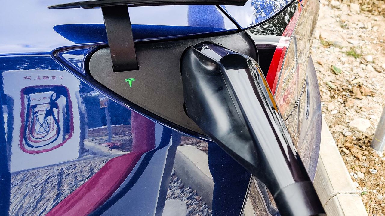 Tesla Model 3 charging at station