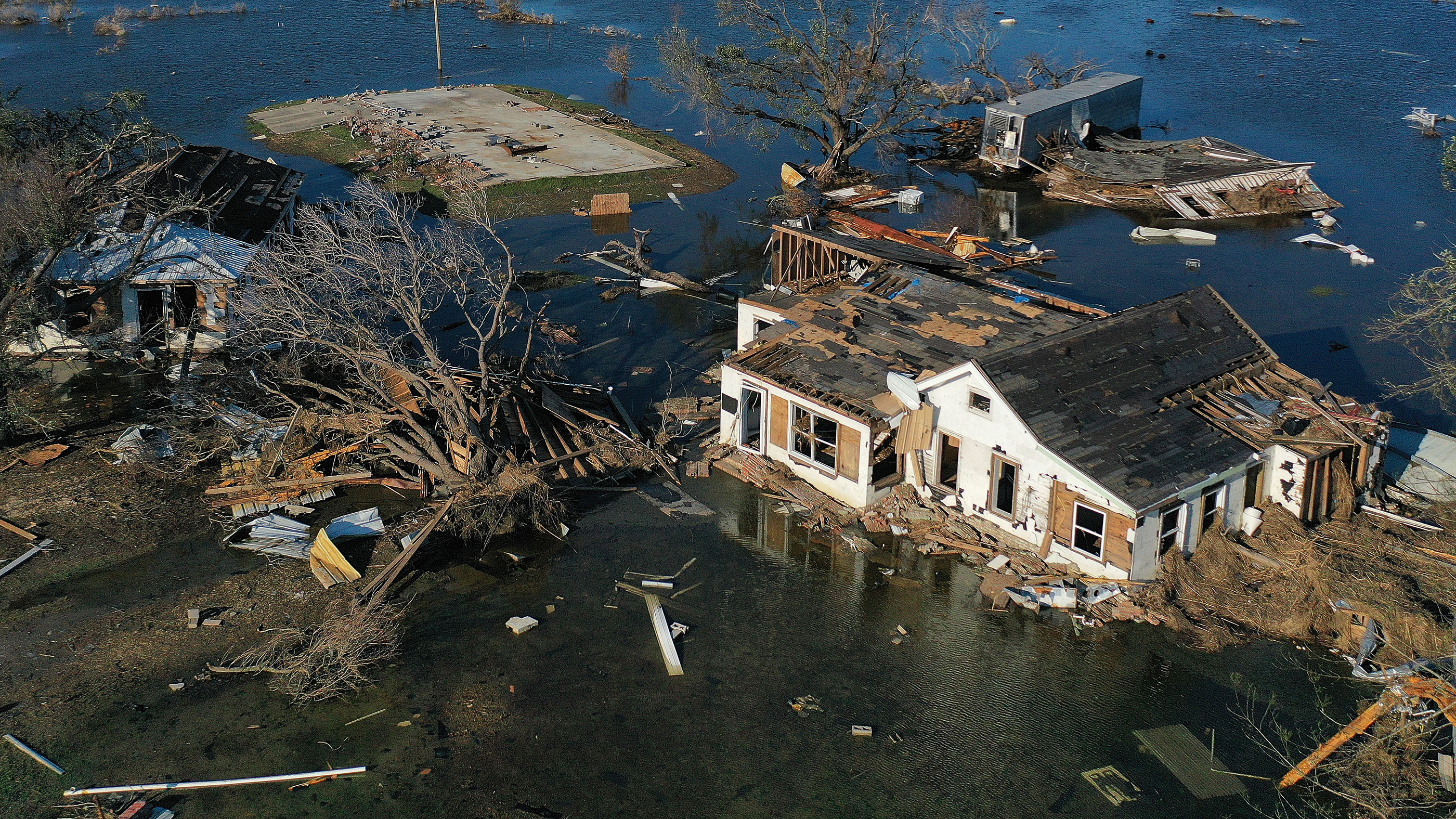 Global warming is expected to intensify hurricanes. Shown here, an aerial view of flood waters from Hurricane Delta on Oct. 10, 2020, surrounding structures destroyed by Hurricane Laura, in Creole, Louisiana.