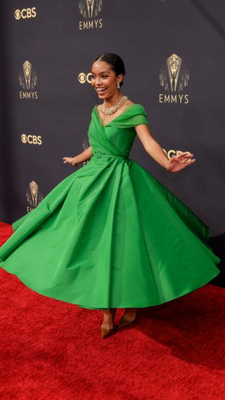 Yara Shahidi twirling in a green Dior gown