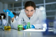 Female scientist examining liquid in laboratory
