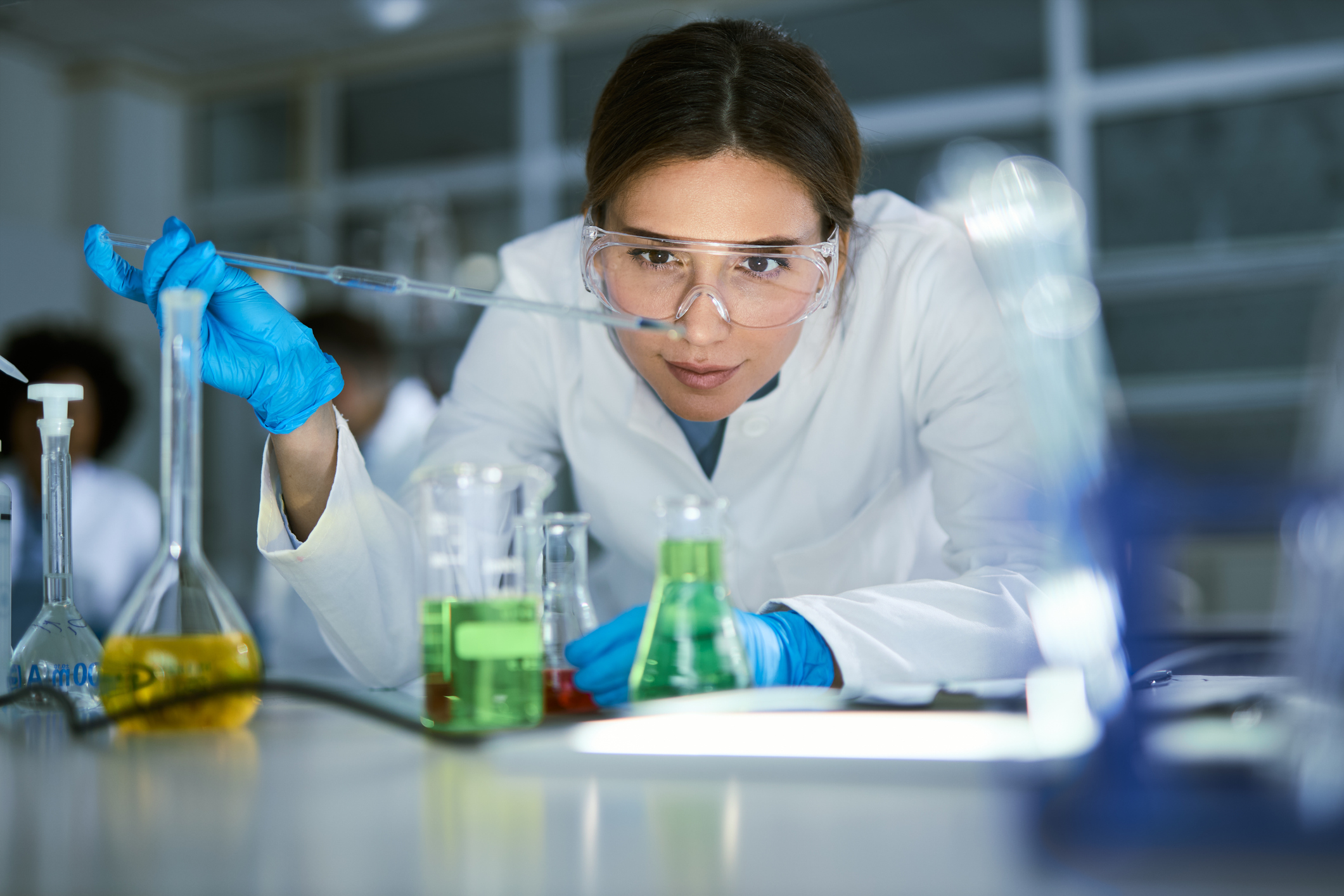 Female scientist examining liquid in laboratory