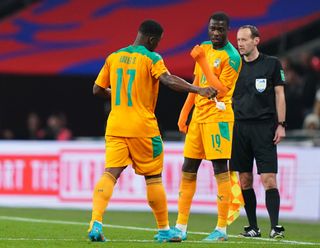 Serge Aurier (left) leaves the game after being shown a red card