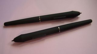 Veikk VK2200 Pro stylus pens on a pastel purple background.