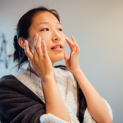 Woman applying a cleanser