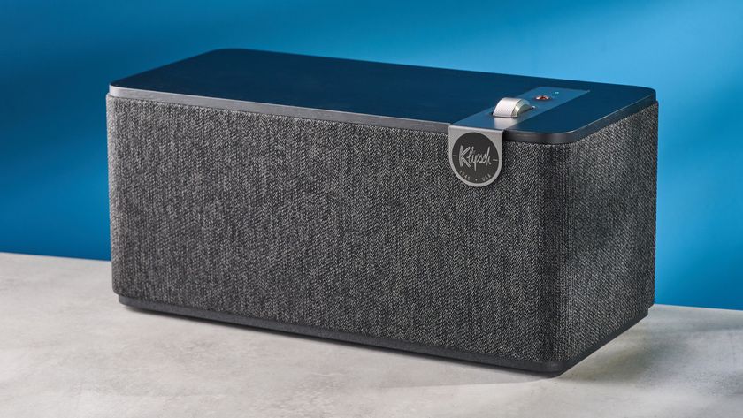 Klipsch The One Plus Bluetooth speaker in matte black photographed in front of a blue background.