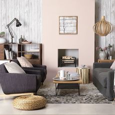 living area with wooden wall and grey sofa with cushions