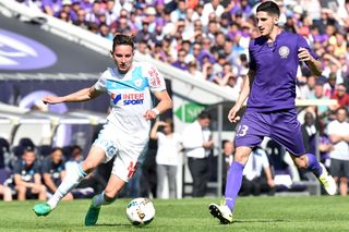 Marseille's Florian Thauvin (left) vies for the ball with Toulouse midfielder Yann Bodiger in April 2017.