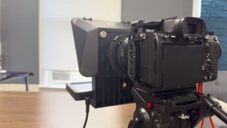 A rear view of the Elgato Prompter attached to a DSLR camera