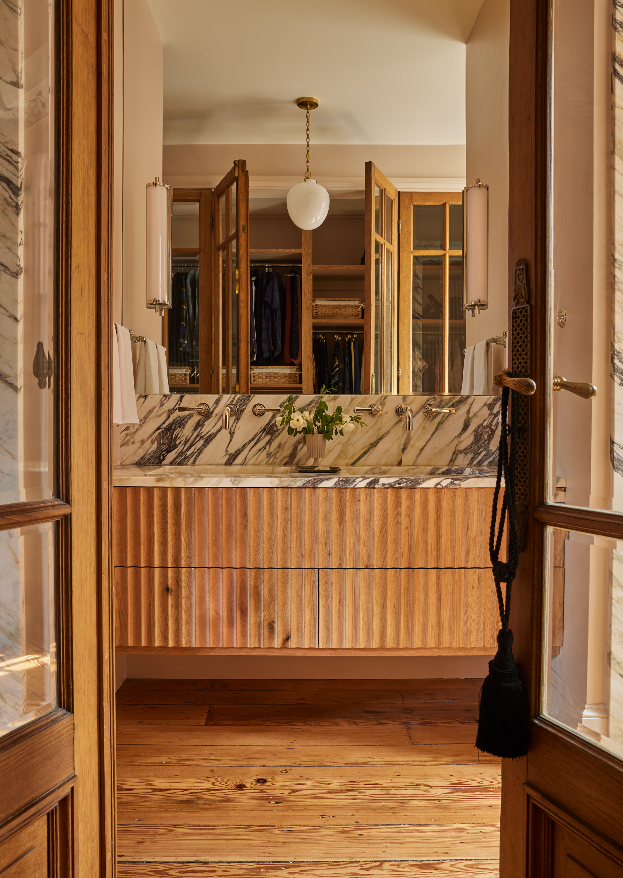 A bathroom with wood planks used on the flooring
