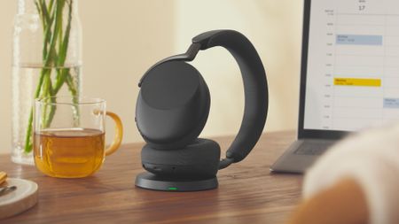 The Jabra Evolve3 85 and 75 at a desk and being worn.