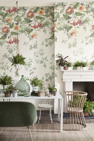 Floral green dining room with leaf wallpaper and white table by Little Greene