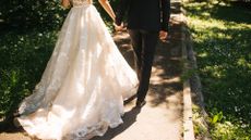 Anonymous wedding couple holding hands