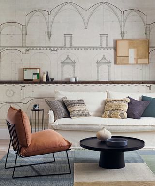 A living room with white sofa and wallpaper with architectural drawing design