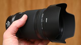 Nikon Z 35mm f/1.2 S product shot with lens held in hand