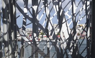 Looking through the metal lattice out to the cruise ships on the water