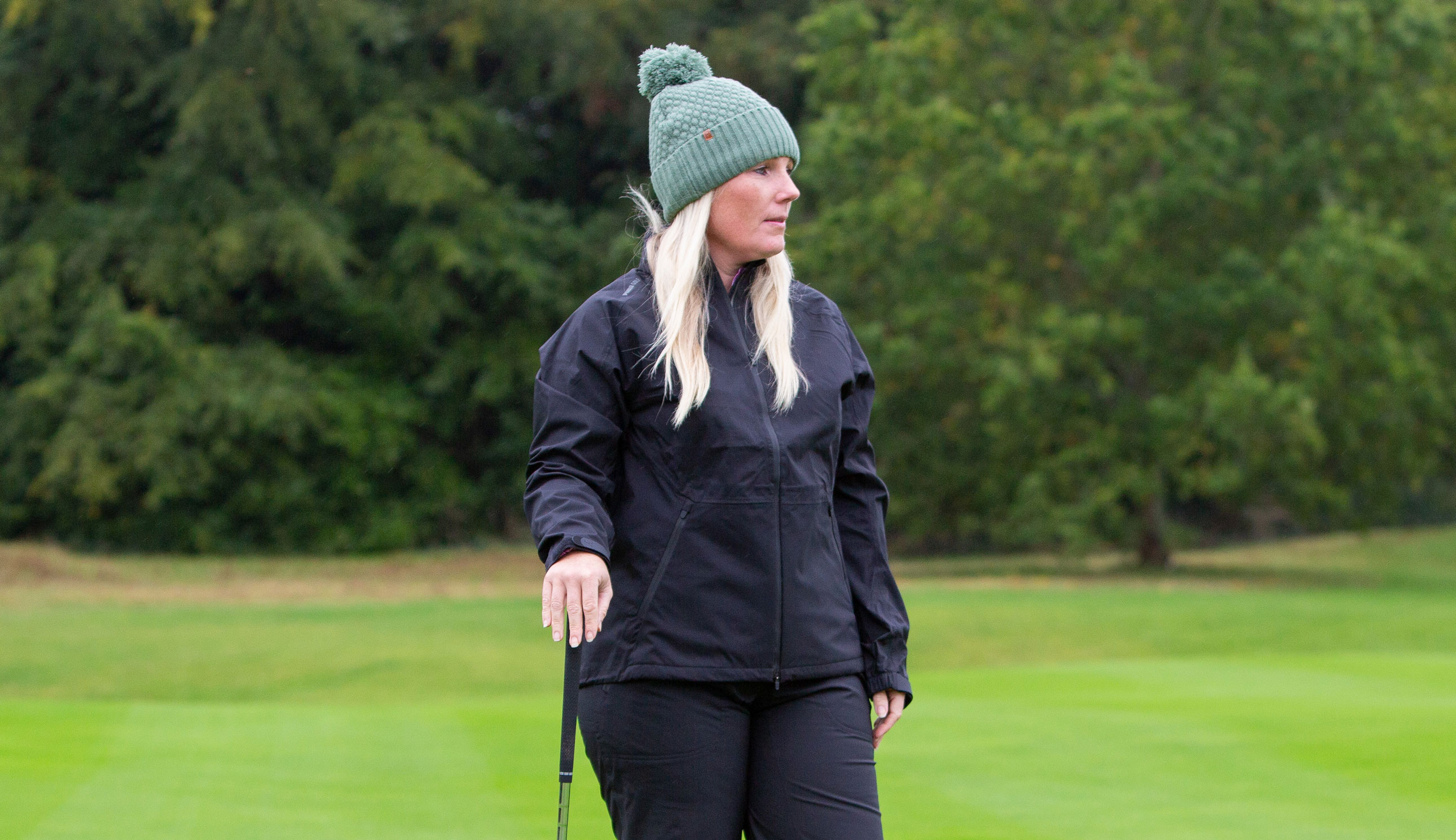 A golfer wears the Puma DRYLBL Waterproof Rain Jacket