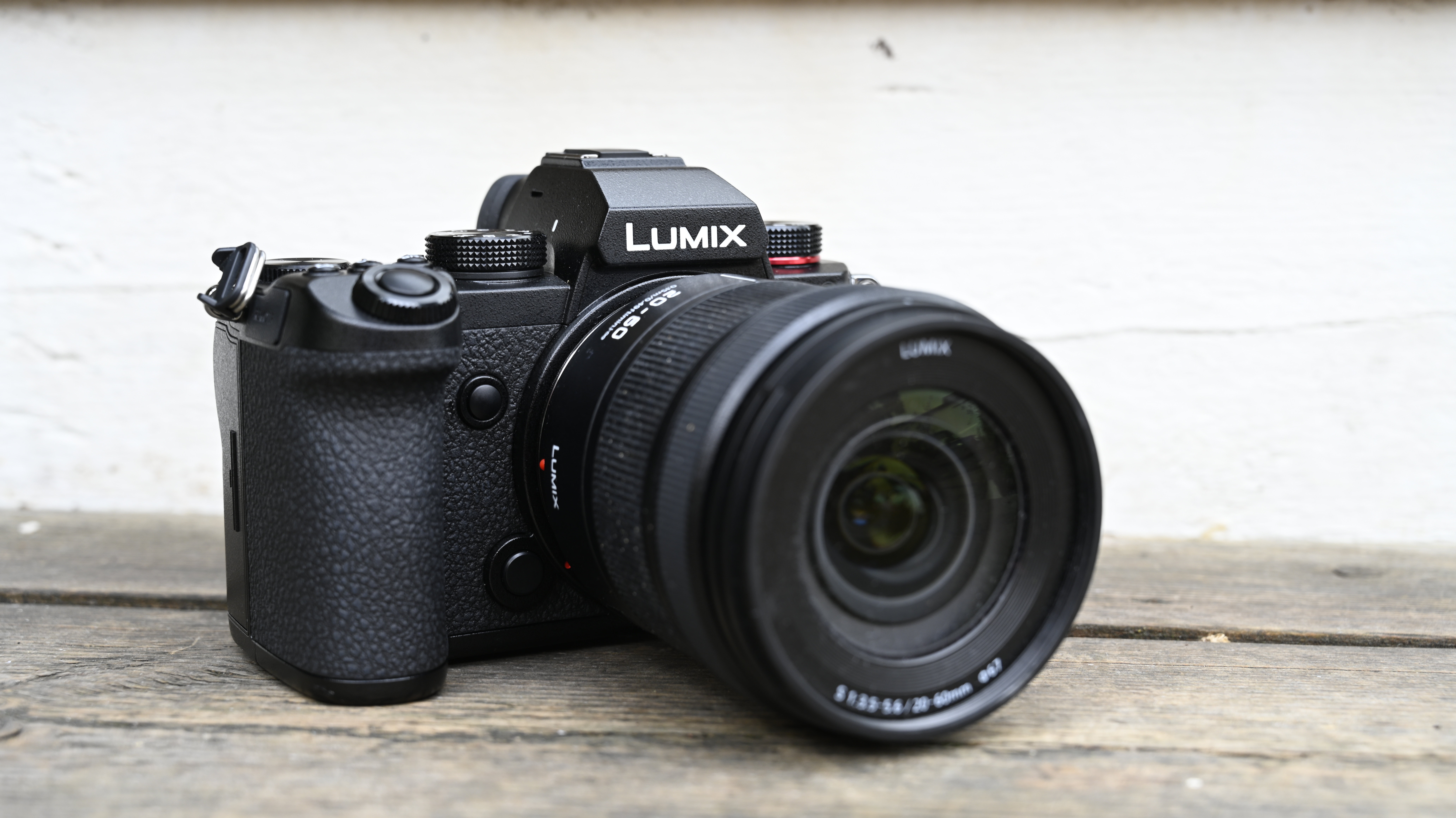 Angled shot of the Panasonic Lumix S5 on a wooden bench with its 20-60mm lens