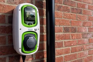 A Rolec, domestic, electric car charging point on the wall of a home.