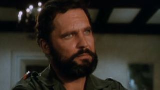 John Vernon with a beard looking serious in Topaz