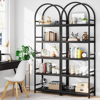 Two arched black open bookshelves