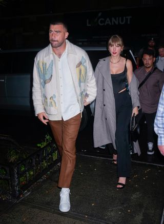 Travis Kelce and Taylor Swift walk in New York City on a date where Taylor wears a corset top and pants