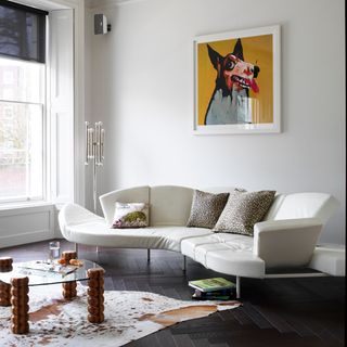 white living room with sofa and wall painting