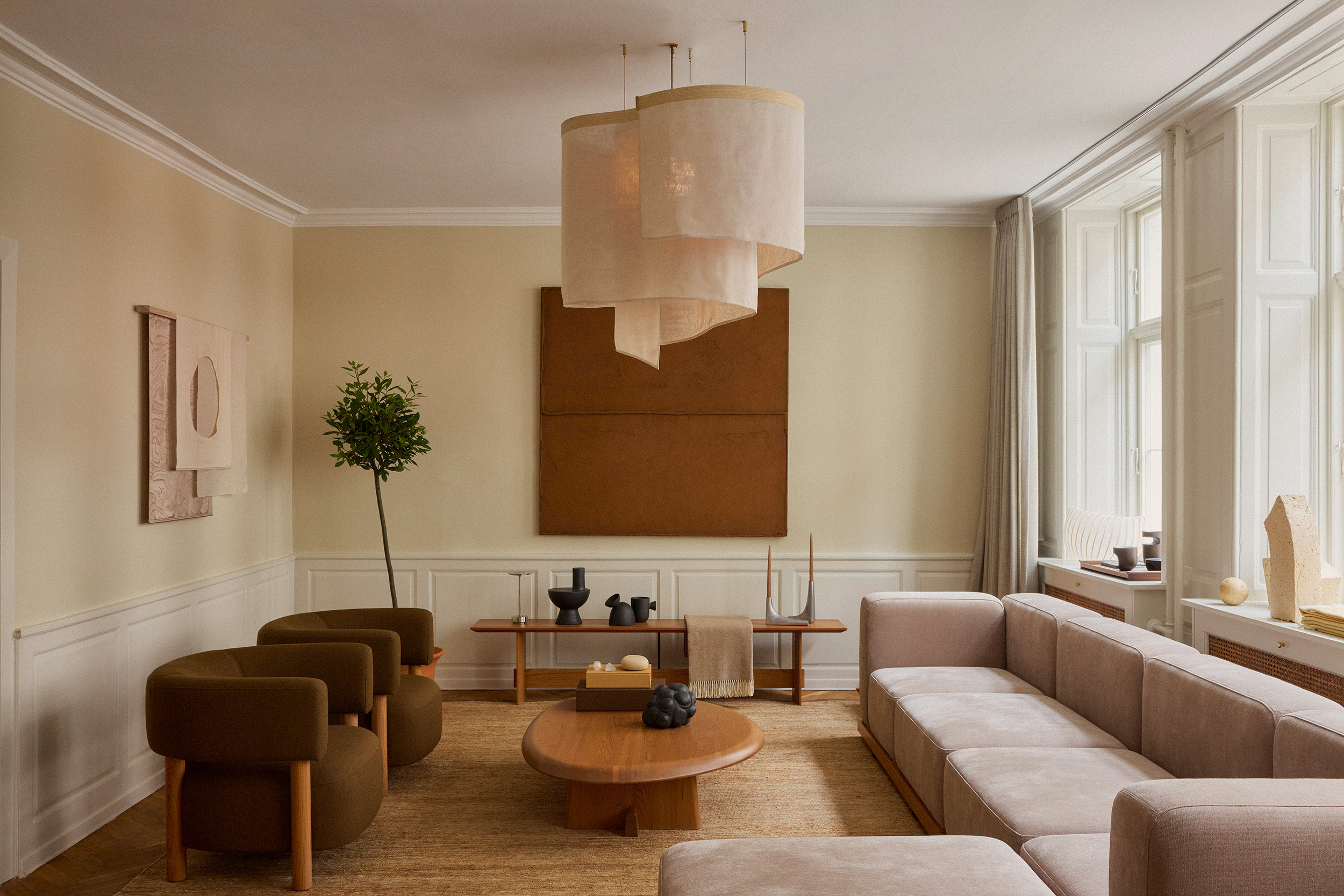 A living room with a fabric, billowing chandelier hanging in the center.