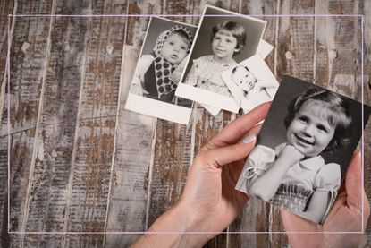 A close up of a woman holding black and white photos of children