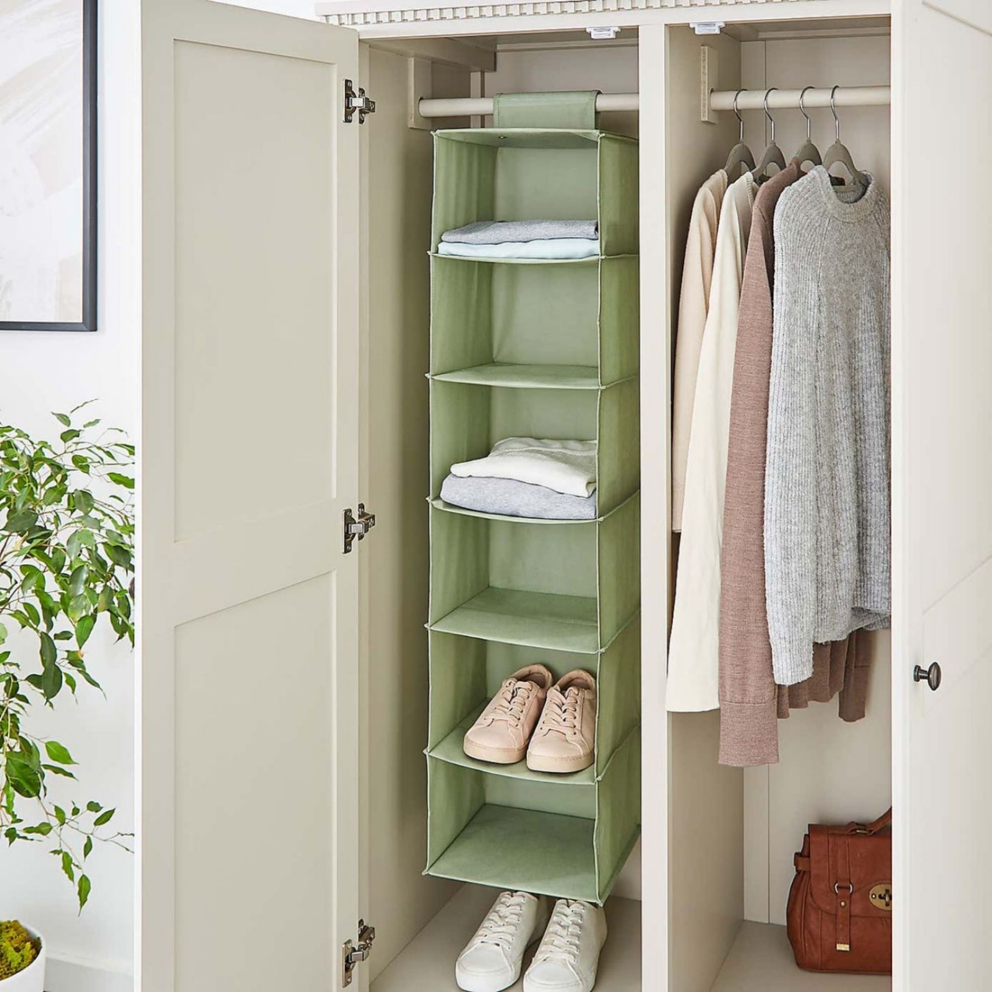 Sage green Dunelm Fabric Hanging Organiser hanging in a wardrobe