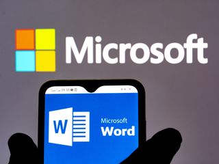 Microsoft Word logo seen displayed on a smartphone with Microsoft logo in the background