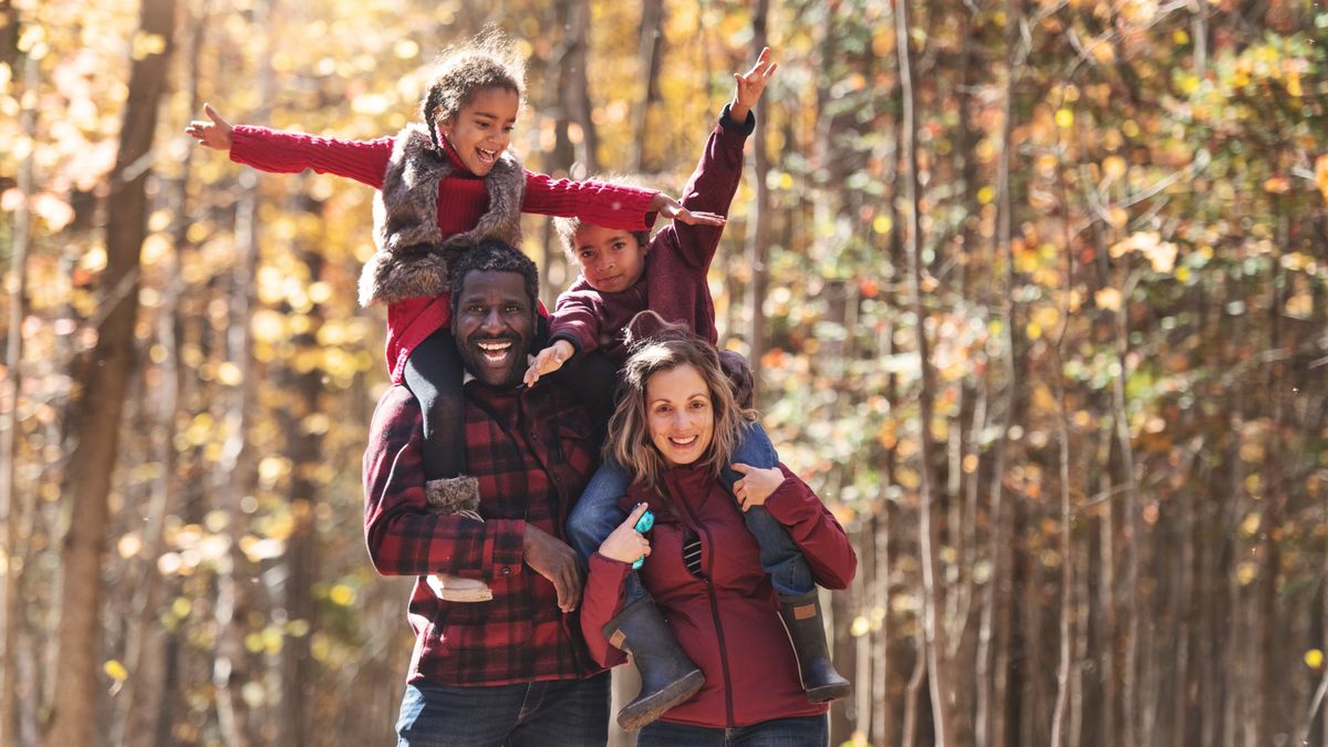 Happy family hiking in woods