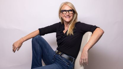 Mel Robbins, who spoke about protein coffee with Dr Stacy Sims, sitting on chair against studio backdrop