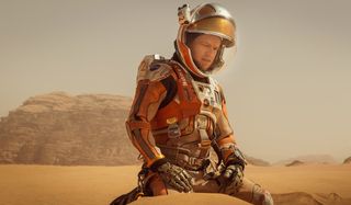 The Martian Matt Damon sits on the sands of Mars