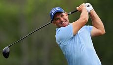 Padraig Harrington grimaces whilst striking his tee shot