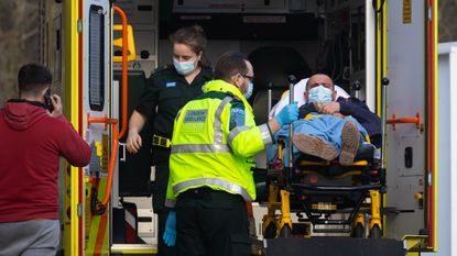 Ambulance staff unload a patient at St Thomas' Hospital, London