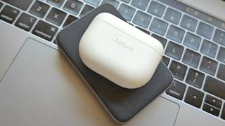 Jabra Elite 10 in charging case on top of keyboard