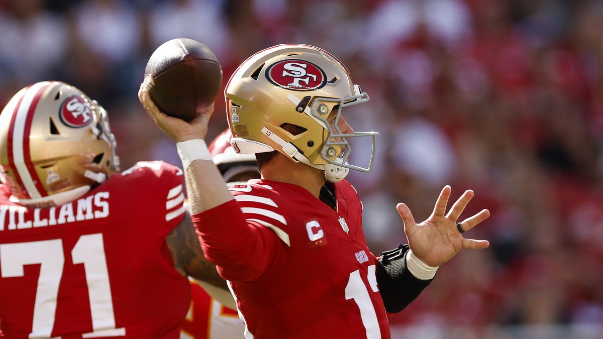 Brock Purdy #13 of the San Francisco 49ers, wearing a gold helmet, throws a pass ahead of the 49ers vs Cowboys game in the NFL 2024/25