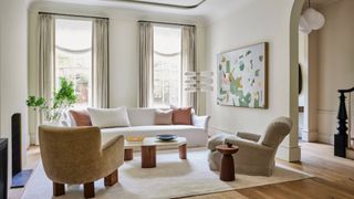 A clean home with accent chairs and a white sofa